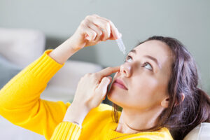 Woman using eyedrops